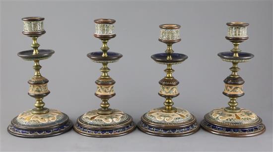 Frank A Butler for Doulton Lambeth, a set of four brass mounted candlesticks, c.1890, 20cm, one restored